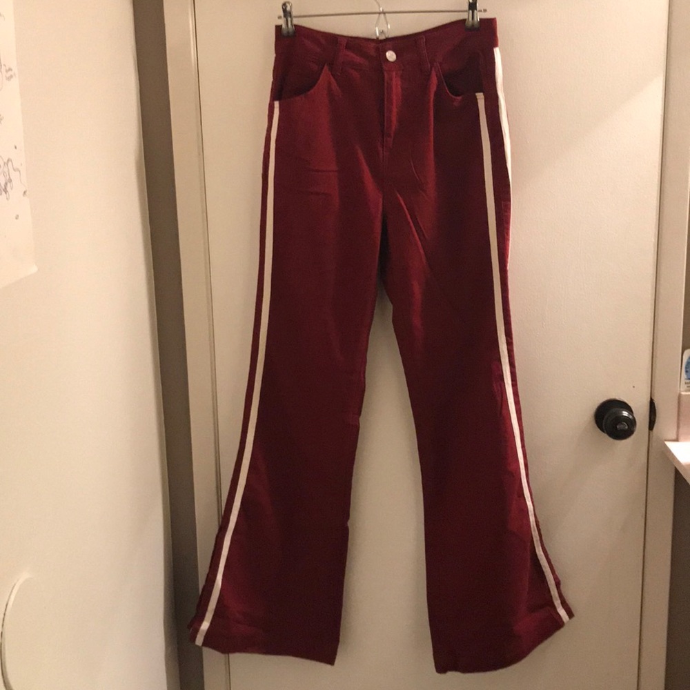 red flare jean with two white stripes on sides